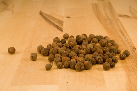 Allspice fruits on wood