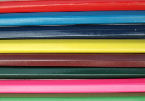 Color pencils form abstract lines pattern       
