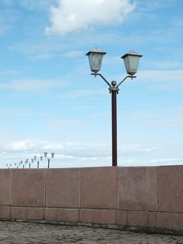 Lanterns behind a fencing on quay. Russia  