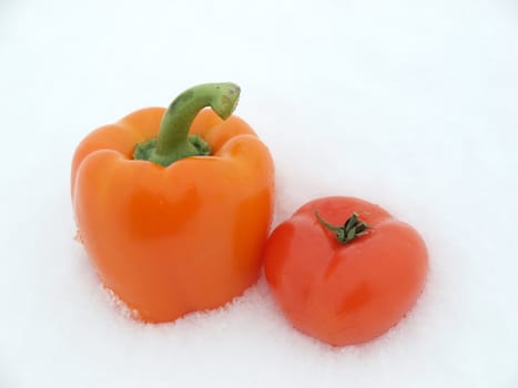 Pepper and tomato on a snow        