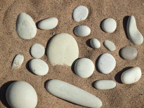 White pebble on sand on coast of lake      