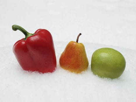 Pepper, pear and apple on a snow.       