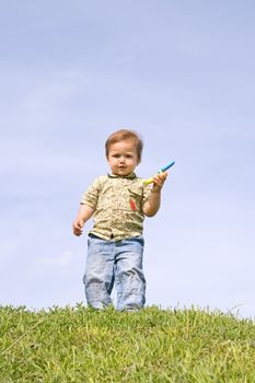 Little boy holding toy cellphone