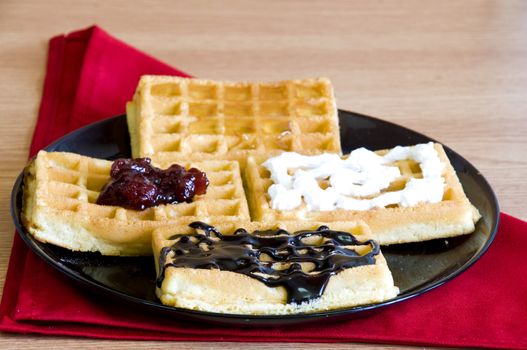 breakfast waffles, jam, chocolate, honey and whip cream