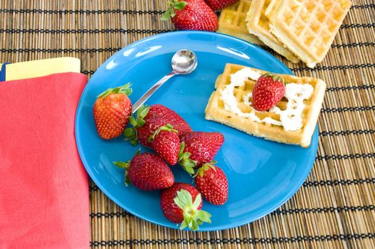 homemade light dessert, waffles with strawberries with light cream