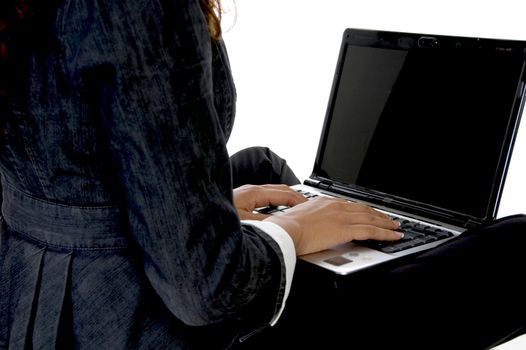 fingers on keyboard of laptop
