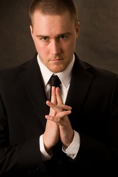 Portrait of a young businessman on dark background
