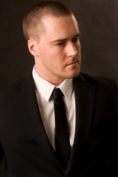 Portrait of a young businessman on dark background