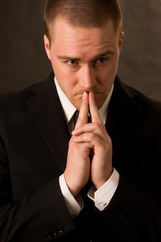 Portrait of a young businessman on dark background