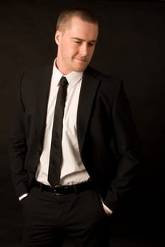 Portrait of a young businessman on dark background