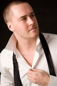 Portrait of a young businessman on black background