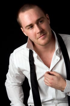 Portrait of a young businessman on black background