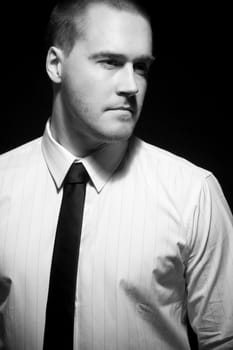 Portrait of a young businessman in black and white