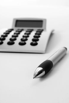 Pen and calculator (business background)