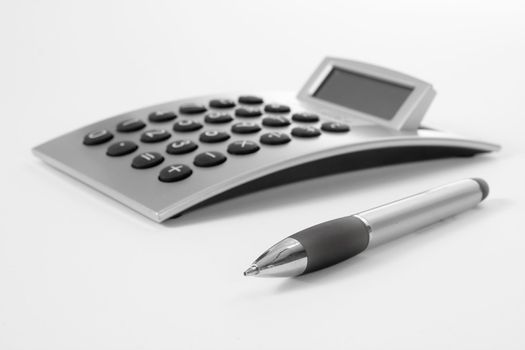 Pen and calculator (business background)