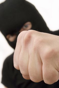 evil criminal wearing military mask and throwing the fist