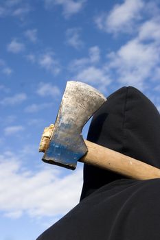 man with an axe on sky background