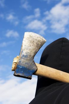 man with an axe on sky background