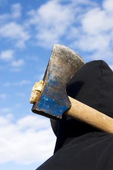 man with an axe on sky background