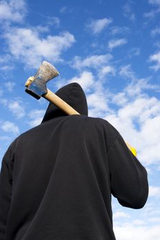 man with an axe on sky background