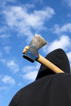 man with an axe on sky background