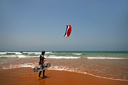 kite surfer walking along the beach to have another go
