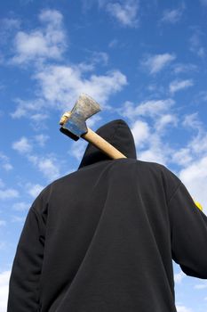 man with an axe on sky background