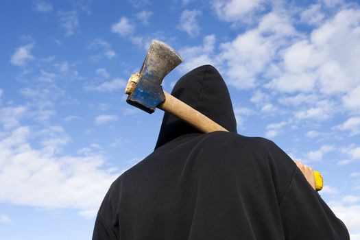 man with an axe on sky background