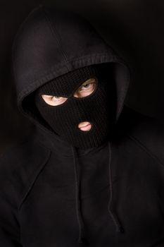 evil criminal wearing balaclava