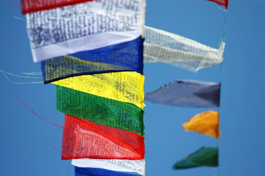 Prayer flags against a background of the blue sky