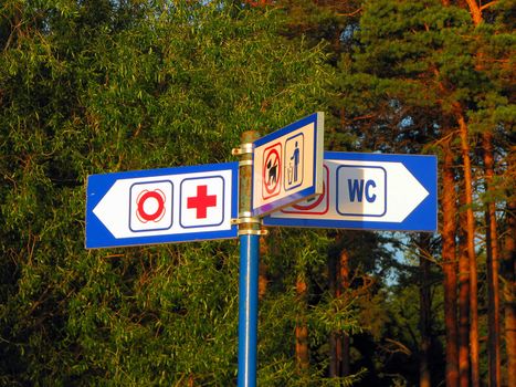 Metal sign with directions on the beach