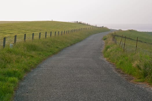 A road on the dike on the former island Wieringen seems to end in the sea.