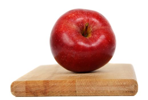 red apple on wood cutting plank