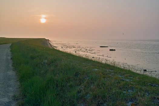 The sun sets at the coast of Wieringen, a former island in the north-west of the Netherlands
