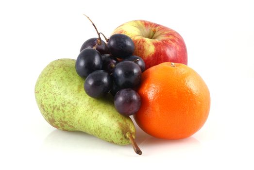 Apple, pear, orange and a bunch of grapes on a white background.                