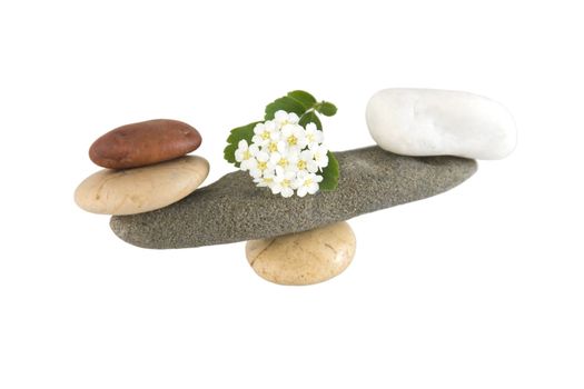 Front view of balancing stones over a white background with reflection