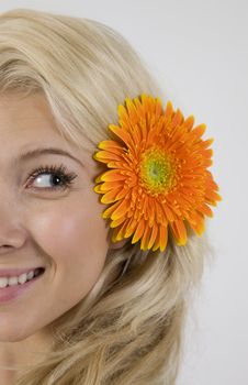 pretty model with flower in her hair on isolated studio pictures