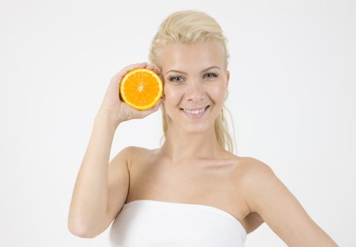 waist-up pose of model with slice of orange on isolated studio pictures