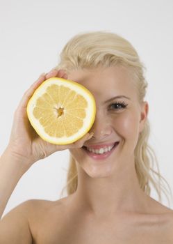 smiling face of model with slice of lemon on isolated studio pictures