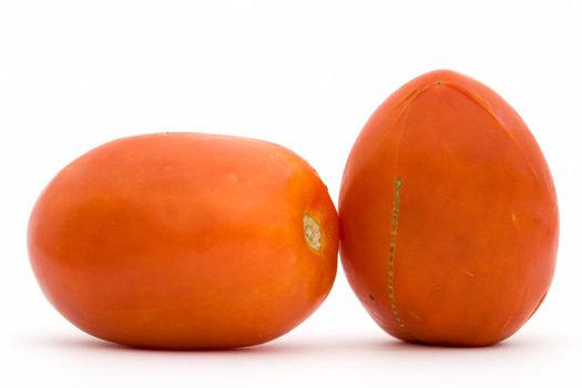 Two red tomatoes on a white background