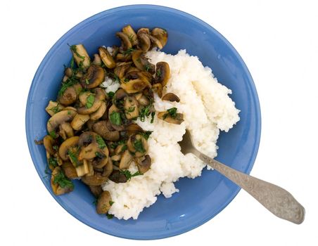 Champignons and rice on a blue plate on a white background.