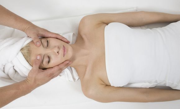 woman receiving face massage  on white background