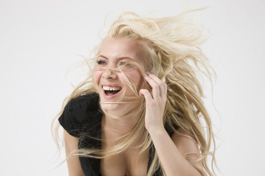 beautiful young woman expressing positivity against white background