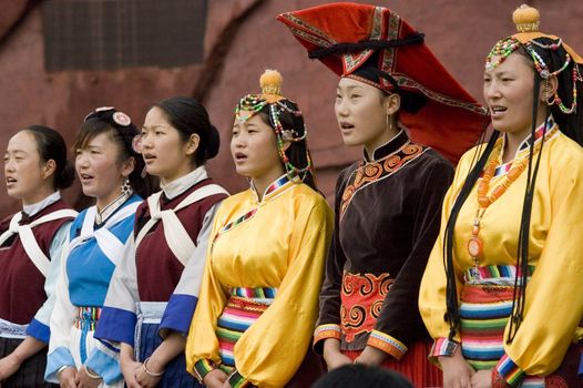 CHINA, YUNNAN PROVINCE, LIJIANG CITY - SEPTEMBER 14: representants of different minorities in traditional clothes, performing show for tourists.