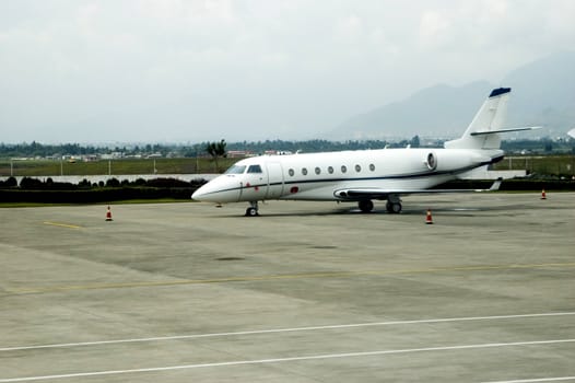 Small jet plane parked at Lijiang airport in Yunnan province, China.