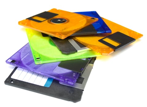 several diskettes of different color on white background. Isolation. Shallow DOF
