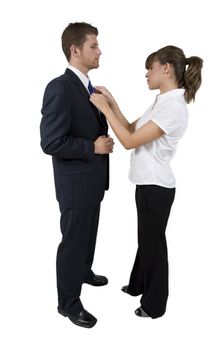 woman holding tie of man on white background