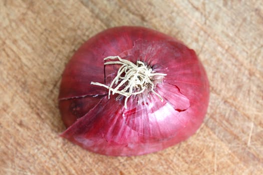 A sliced red onion on a wooden background