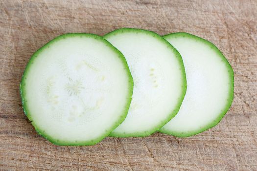 Courgettes on a wooden background