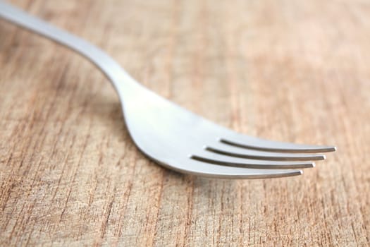 A fork on a wooden background